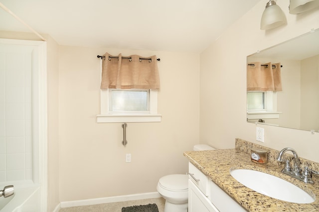 bathroom with vanity, toilet, and a healthy amount of sunlight