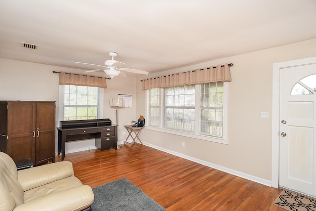 living room featuring hardwood / wood-style flooring and ceiling fan