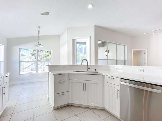 kitchen featuring dishwasher, white cabinets, sink, hanging light fixtures, and vaulted ceiling