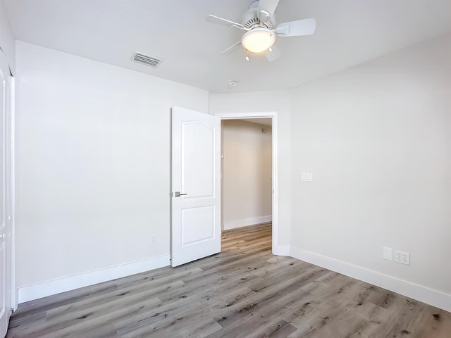 unfurnished room featuring ceiling fan and light wood-type flooring