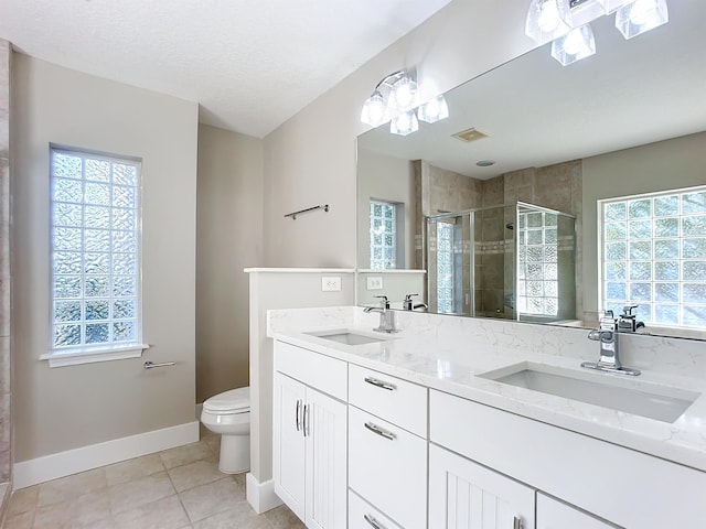 bathroom with vanity, a shower with door, tile patterned floors, and plenty of natural light