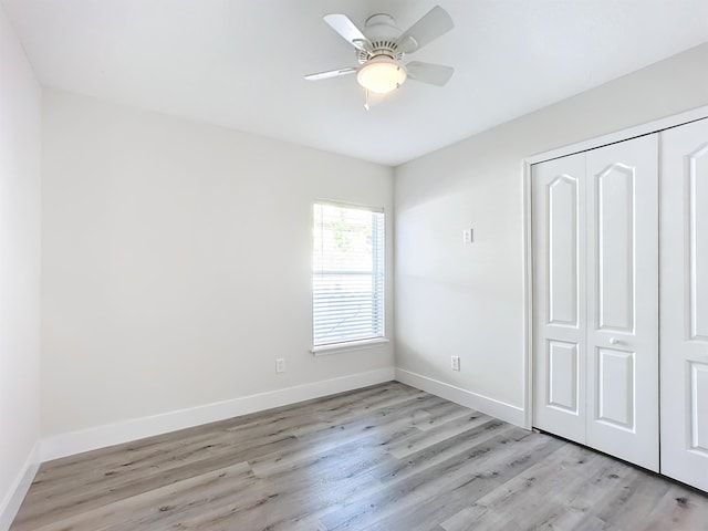 unfurnished bedroom featuring a closet, ceiling fan, and light hardwood / wood-style flooring