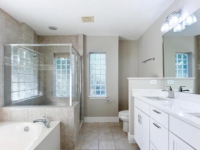 full bathroom with toilet, tile patterned floors, a wealth of natural light, and independent shower and bath