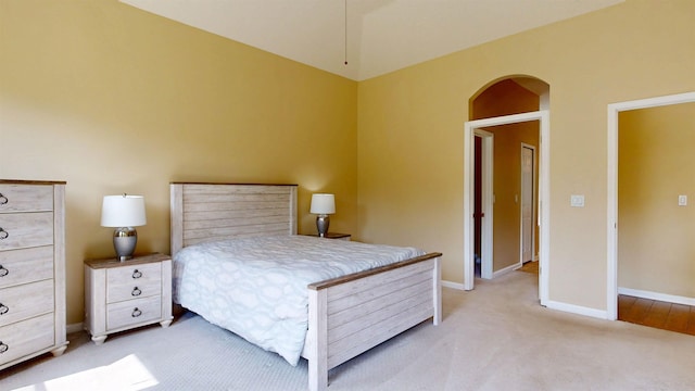 256 N Hidden Tree Dr, Saint Augustine, FL 32086 - bedroom with light carpet, baseboards, and arched walkways