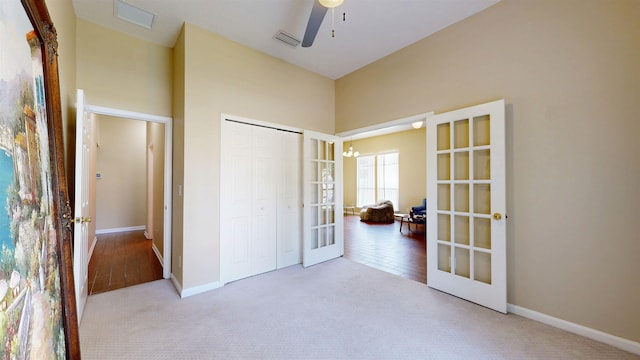 256 N Hidden Tree Dr, Saint Augustine, FL 32086 - unfurnished bedroom featuring french doors, carpet floors, a closet, and a high ceiling