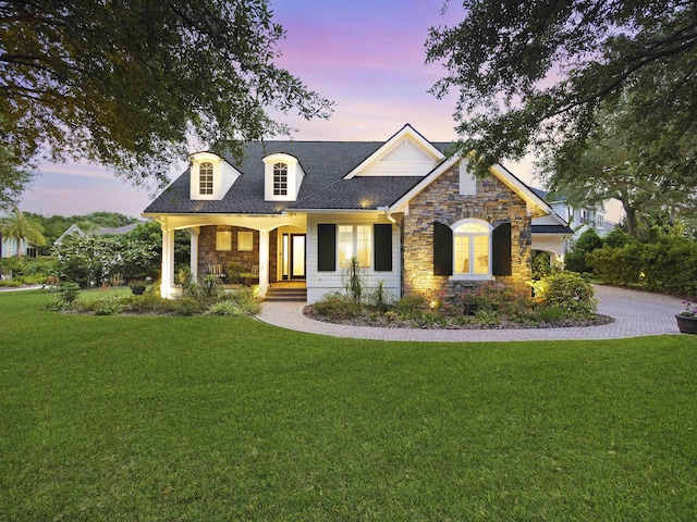 476 Ocean Forest Dr, Saint Augustine, FL 32080 - view of front of property with a lawn, a porch, a shingled roof, and stone siding