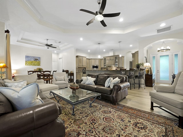 476 Ocean Forest Dr, Saint Augustine, FL 32080 - living area featuring a tray ceiling, arched walkways, ornamental molding, and a ceiling fan