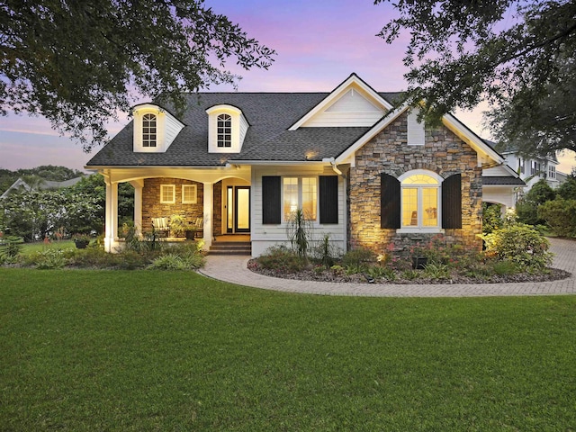476 Ocean Forest Dr, Saint Augustine, FL 32080 - view of front facade featuring a porch, a front yard, a shingled roof, and stone siding