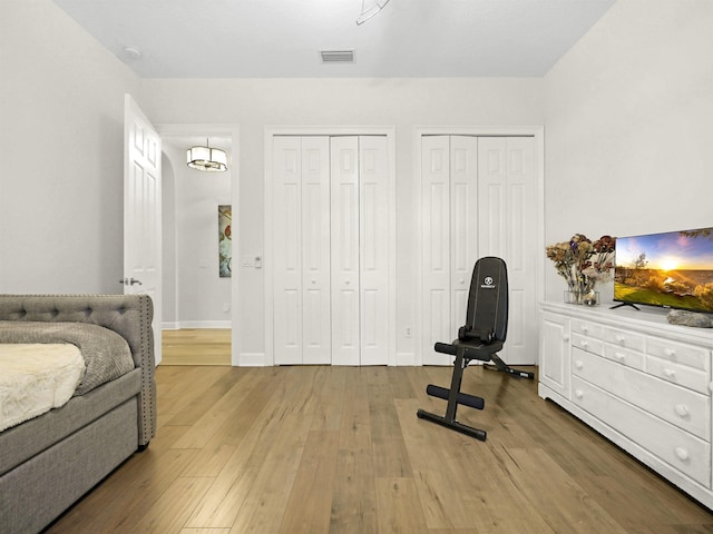476 Ocean Forest Dr, Saint Augustine, FL 32080 - bedroom with wood finished floors, baseboards, and two closets