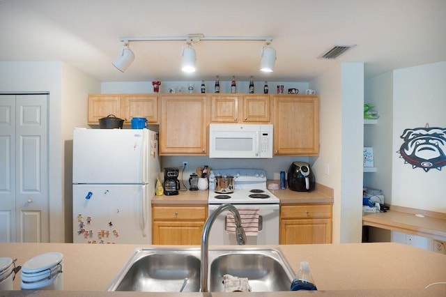 410 S Villa San Marco Dr Unit 301, Saint Augustine, FL 32086 - kitchen featuring white appliances, a sink, light brown cabinets, and light countertops