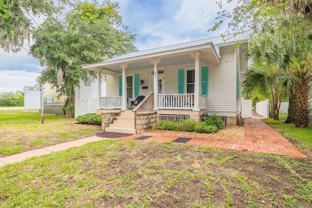 bungalow with a front yard and a porch