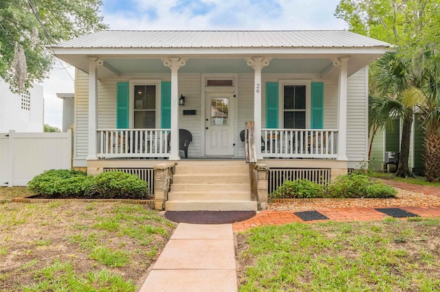 bungalow with covered porch and a front yard