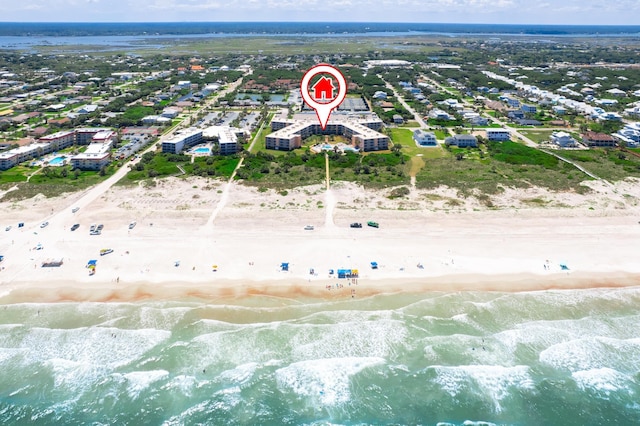 bird's eye view featuring a water view and a beach view