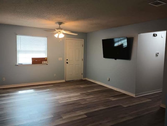 304 Las Olas Rd, Saint Augustine, FL 32084 - empty room with a textured ceiling, ceiling fan, and dark wood-style floors