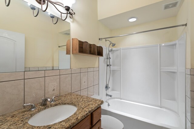 full bathroom featuring tasteful backsplash, toilet, vanity, and tub / shower combination