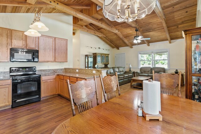 kitchen with black appliances, decorative light fixtures, beam ceiling, and high vaulted ceiling