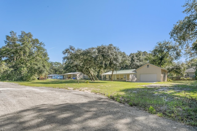 ranch-style house with a garage and a front lawn