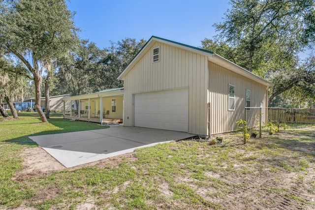 view of home's exterior with a porch, a garage, and a lawn