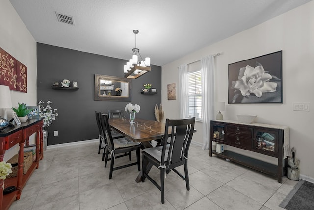 811 Sandstone Dr, Saint Augustine, FL 32086 - dining area with an inviting chandelier, light tile patterned flooring, baseboards, and visible vents