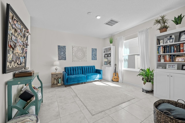 811 Sandstone Dr, Saint Augustine, FL 32086 - tiled living area with visible vents, baseboards, and a textured ceiling
