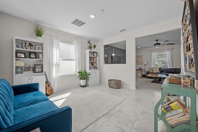 811 Sandstone Dr, Saint Augustine, FL 32086 - living room with tile patterned flooring, visible vents, baseboards, and ceiling fan