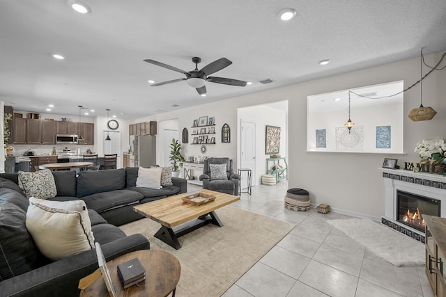811 Sandstone Dr, Saint Augustine, FL 32086 - living area with light tile patterned floors, visible vents, recessed lighting, ceiling fan, and a glass covered fireplace