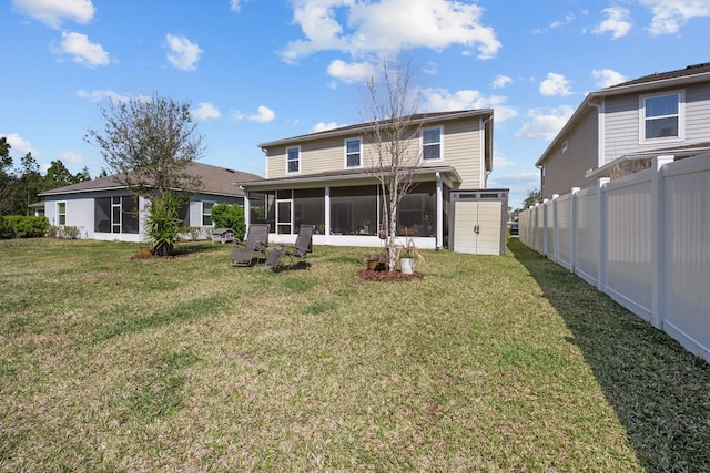 811 Sandstone Dr, Saint Augustine, FL 32086 - back of house featuring an outdoor structure, a lawn, fence private yard, and a sunroom