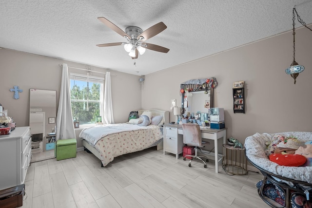 811 Sandstone Dr, Saint Augustine, FL 32086 - bedroom with light wood finished floors, a textured ceiling, and a ceiling fan