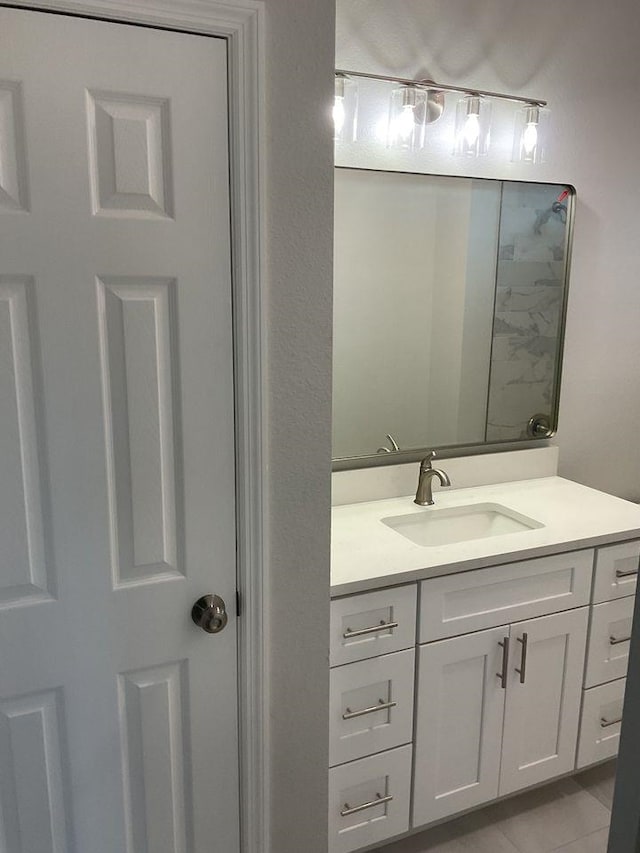 bathroom with tile patterned flooring and vanity