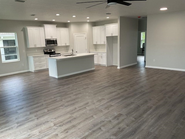 5 Fifer Ln, Palm Coast, FL 32137 - kitchen with stainless steel microwave, range with electric stovetop, a ceiling fan, open floor plan, and recessed lighting