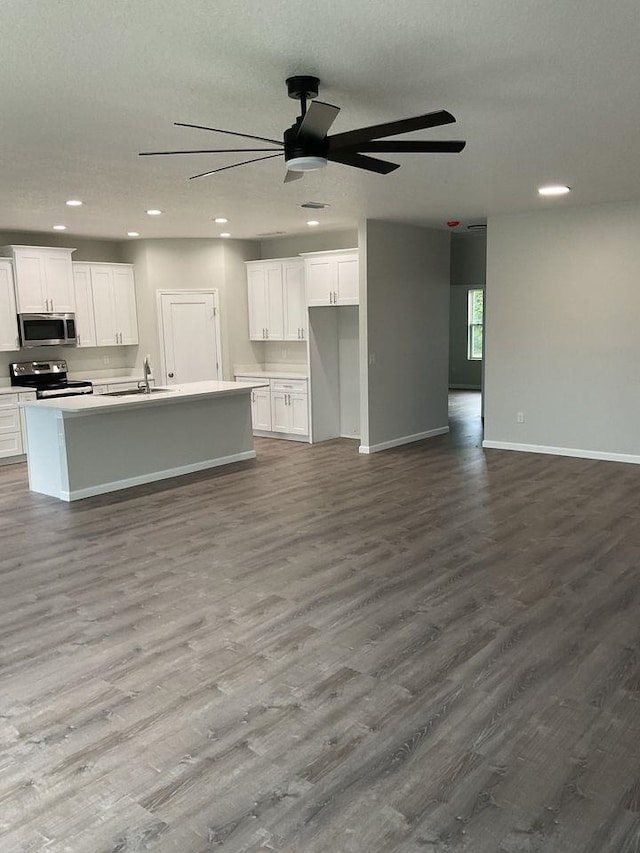 5 Fifer Ln, Palm Coast, FL 32137 - kitchen featuring stainless steel microwave, open floor plan, electric range oven, dark wood-style flooring, and white cabinets