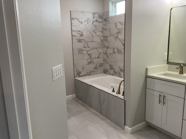 bathroom with tile patterned flooring, vanity, and a bath