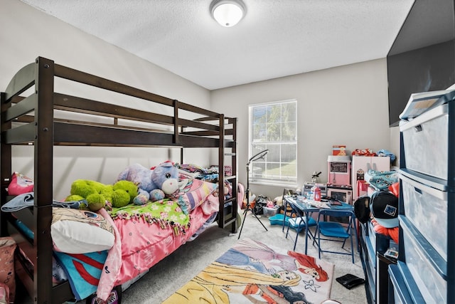 bedroom with carpet and a textured ceiling
