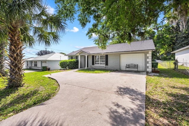 ranch-style house featuring stucco siding, an attached garage, a front lawn, and concrete driveway