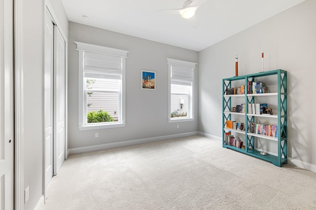 interior space featuring ceiling fan and a closet