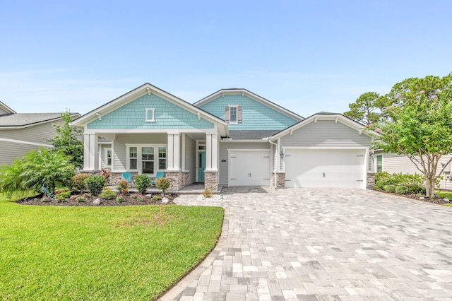 craftsman-style home featuring a front yard and a garage