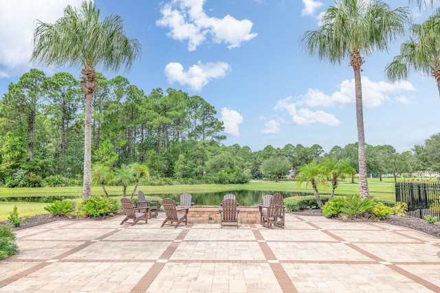 view of patio / terrace featuring a water view and a fire pit