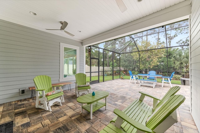 view of patio featuring ceiling fan and glass enclosure