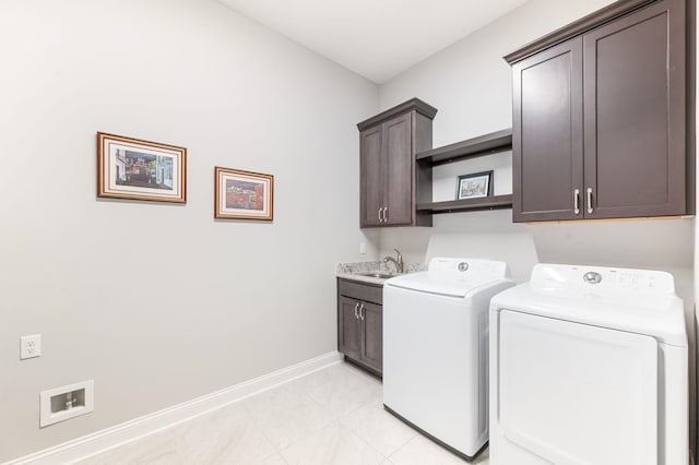 washroom with cabinets, sink, and washing machine and dryer