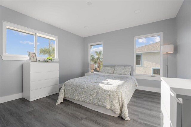 bedroom with dark wood-style floors and baseboards