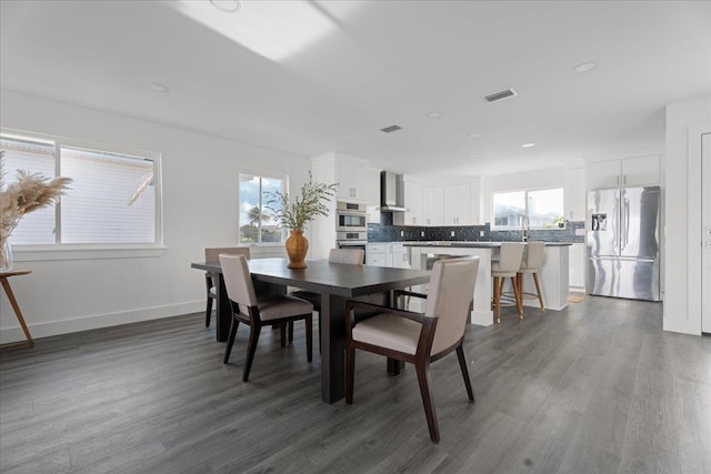 dining room featuring dark wood-type flooring, recessed lighting, baseboards, and visible vents