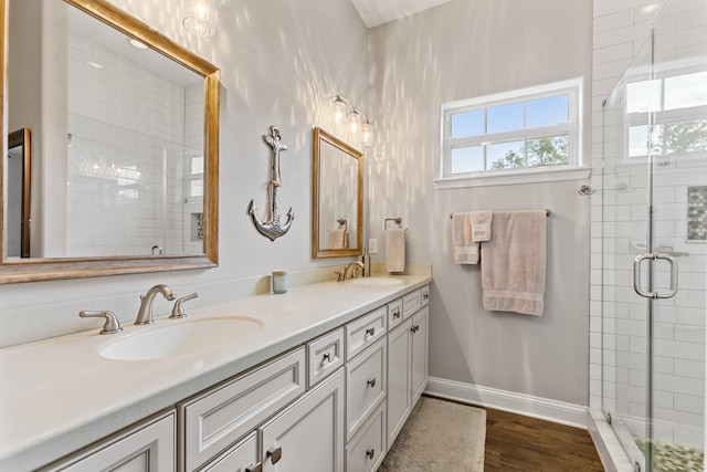 121 Grand Ravine Dr, Saint Augustine, FL 32086 - full bath with double vanity, a stall shower, baseboards, and wood finished floors