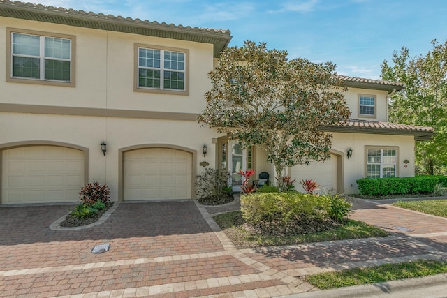 121 Grand Ravine Dr, Saint Augustine, FL 32086 - view of front of home with stucco siding, driveway, a garage, and a tiled roof