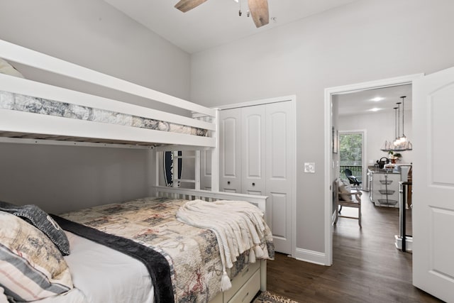 121 Grand Ravine Dr, Saint Augustine, FL 32086 - bedroom with dark wood finished floors, a closet, baseboards, a towering ceiling, and a ceiling fan