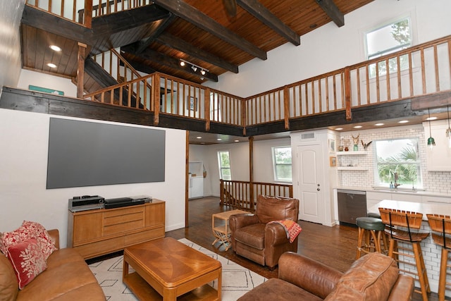 living room featuring high vaulted ceiling, wooden ceiling, a healthy amount of sunlight, and beam ceiling