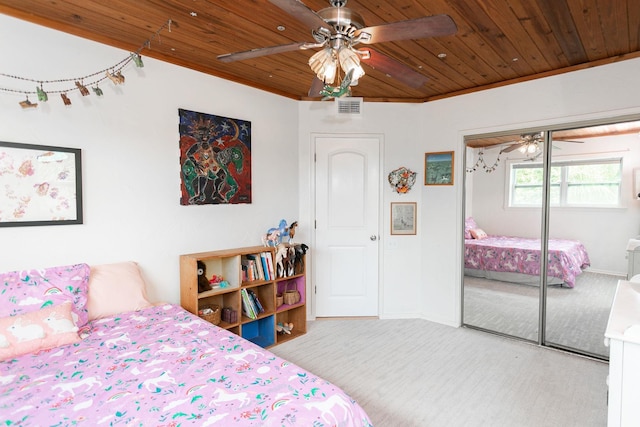 carpeted bedroom featuring a closet, ceiling fan, and wood ceiling