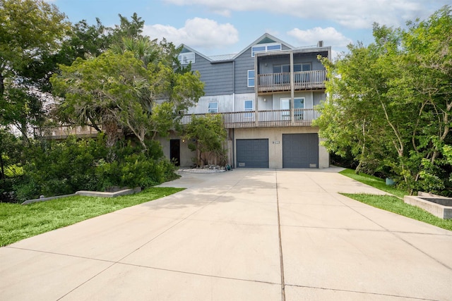 view of front of home featuring a balcony and a garage