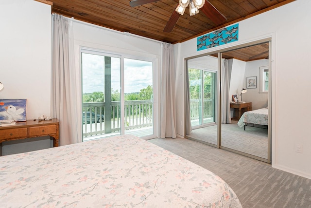 bedroom featuring ceiling fan, access to outside, wooden ceiling, and multiple windows