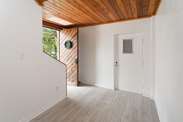 empty room featuring wooden ceiling and light wood-type flooring