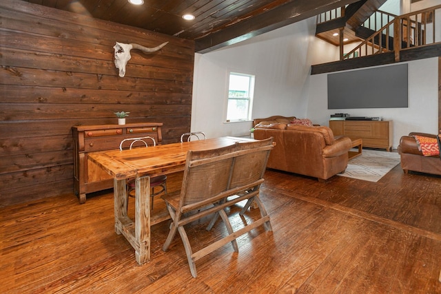 dining room with wood walls and hardwood / wood-style floors